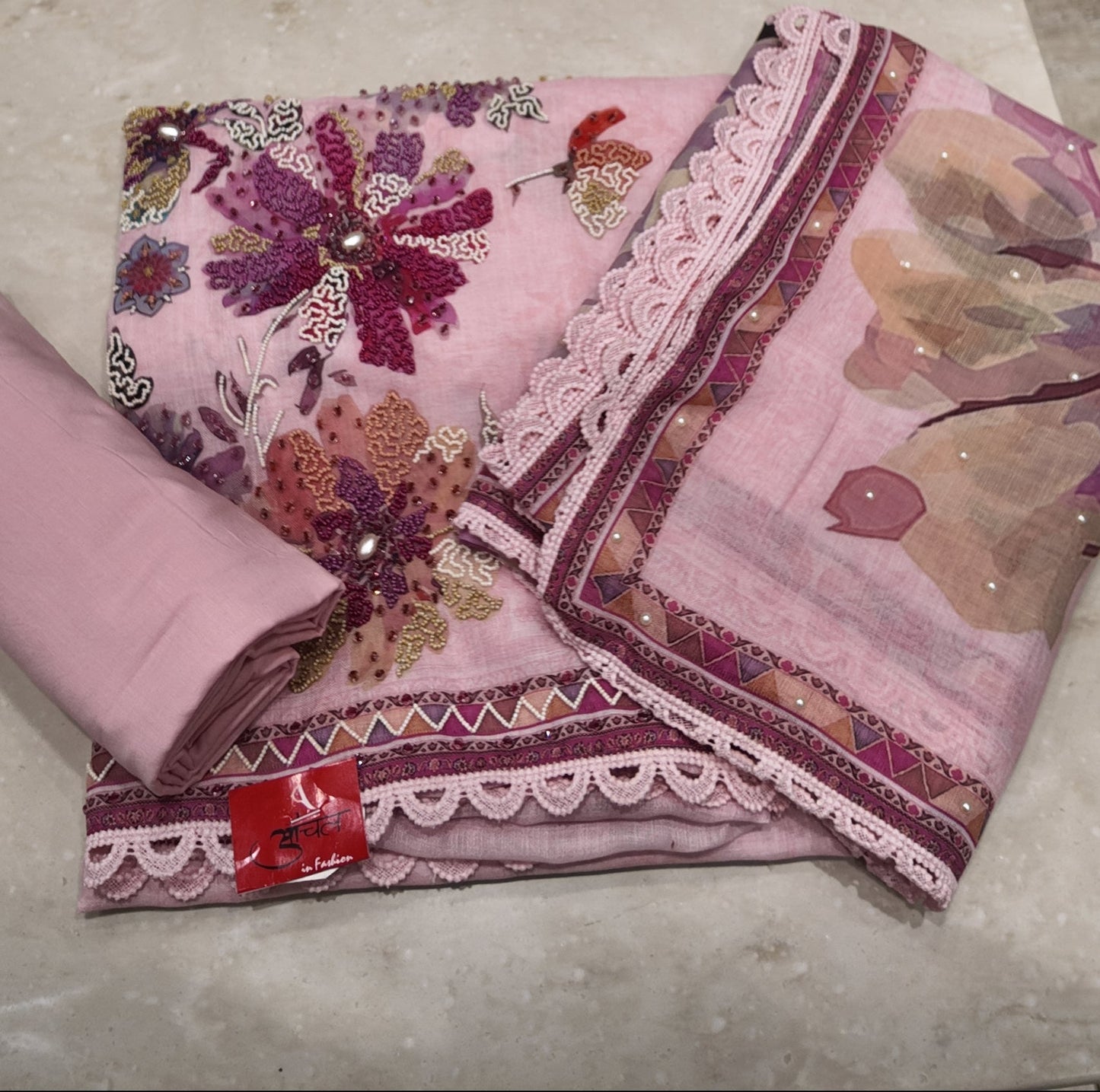 Floral-patterned fabric on a marble surface with a blurred background